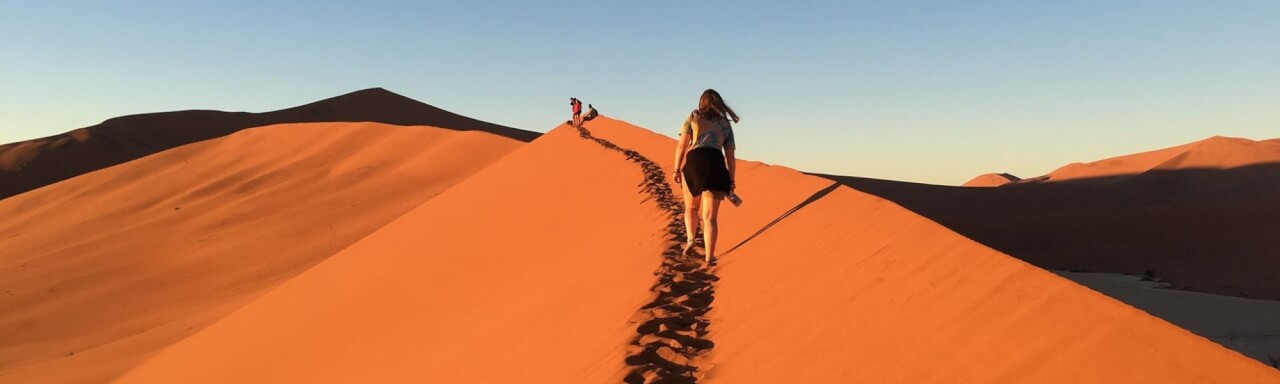 A GVSU student walks along a sand dune in Namibia Africa.